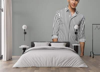 Handsome man looking at camera wear striped shirt isolated on gray background Wall mural