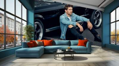 Handsome man with black classic car Wall mural