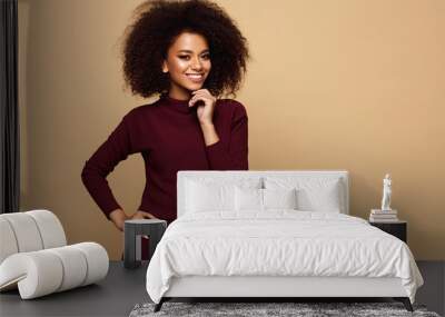 Happy black woman with an afro hairstyle and copy space looking at camera Wall mural