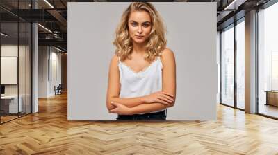 Portrait of beautiful blonde woman over gray background Wall mural