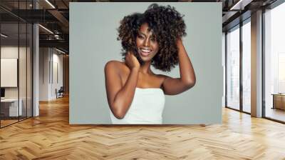 Portrait of cheerful black woman isolated on gray background Wall mural