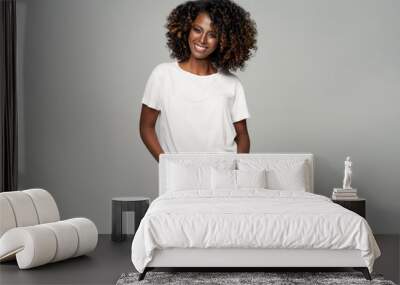 Sexy black woman with afro hair wear classic outfit isolated on gray background Wall mural