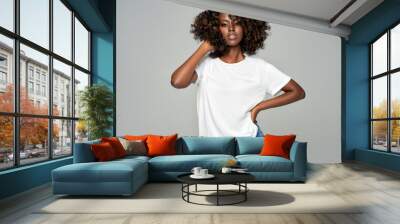 Sexy black woman with afro hair wear classic outfit isolated on gray background Wall mural