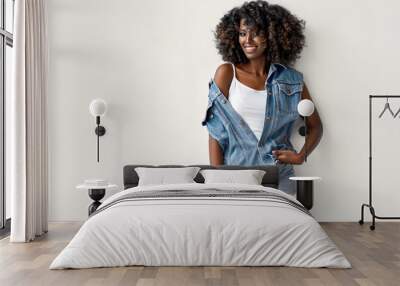 Smiling black girl wear denim clothes with afro hairstyle isolated on white background Wall mural