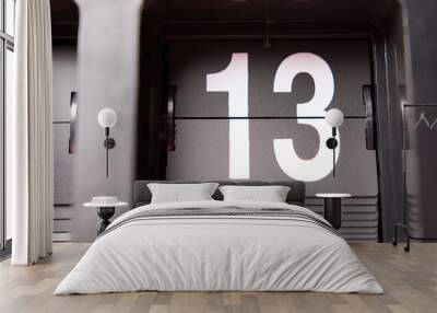 Close-up Flip clock White numbers 13 on black background. Wall mural