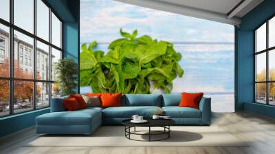 bunch of fresh mint on blue wooden background Wall mural