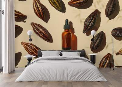 natural skincare serum in a glass dropper bottle surrounded by cacao seeds and  leaves on a sunny background Wall mural