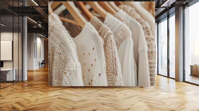 variety of summer clothes on hangers, featuring neutral colors and natural textures for a relaxed look Wall mural