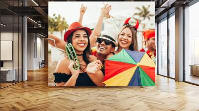 Brazilian Carnival. Group of Brazilian people in costume celebrating the carnival party in the city Wall mural