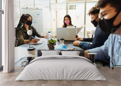 Business team wearing protective masks while meeting in the office during the COVID-19 epidemic Wall mural