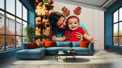 Mother and her baby playing at home on Christmas holiday Wall mural