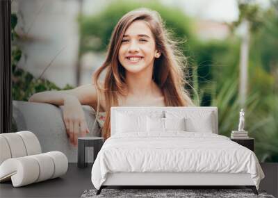 Outdoor portrait of 12 years old girl with long hair Wall mural