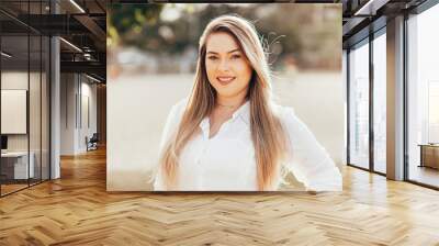 Portrait of beautiful plus size woman in the park Wall mural