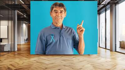 Prostate Cancer Awareness. Man with light Blue Ribbon for supporting people living and illness. Men Healthcare and World cancer day concept Wall mural