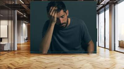 Sad man sitting in dark room. Depression and anxiety disorder concept Wall mural