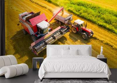 Aerial view of combine harvester on wheat field. Agriculture and carbon footprint theme. Wall mural