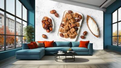 Coconut cookies with dates and carrots in a white bowl on a light background top view. The concept of a healthy snack no sugar Wall mural