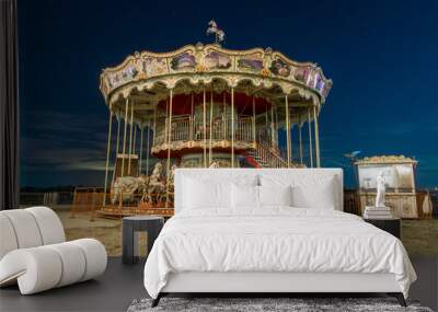 Carousel against the night sky. Vintage carousel with horses at night Wall mural