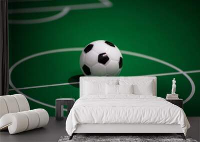 Toy plastic soccer ball on the football field Wall mural