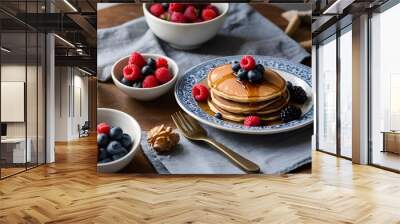 delicious breakfast with pancakes, fresh raspberries and blueberries, maple syrup and a glass of orange juice Wall mural