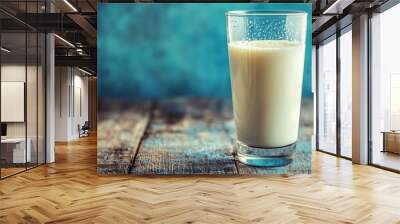 A glass of fresh milk glistens on a rustic table, inviting appreciation of its pure simplicity. Wall mural