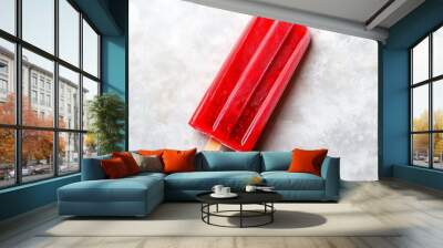 A vibrant red popsicle bursts with strawberry flavor, evoking summer nostalgia and joy. Wall mural