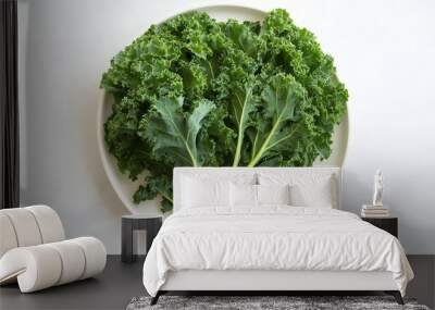 Fresh green kale on a white plate, enhanced by soft light, creates a striking, healthy visual. Wall mural