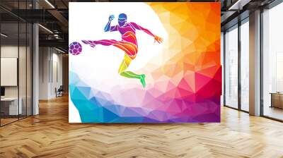 Creative silhouette of soccer player. Football player kicks the ball in trendy abstract colorful polygon style with rainbow back Wall mural