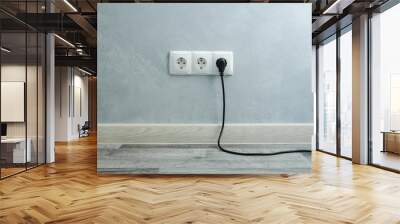 Close-up view of electric outlets with power cables Wall mural