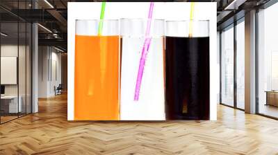 three highball glasses of soda with drinking straws on a white b Wall mural