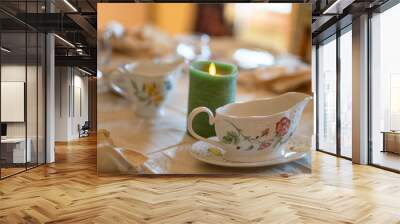 A table with a candle and two cups on it Wall mural