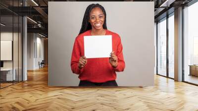 African American woman with blue eyes holding a sign with room for copy. Wall mural