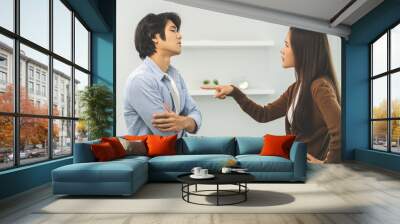 Asian young couple fight standing on white background, relationship in trouble. Different angry, use emotion shouting at each other. Argue husband has expression of disappointment and upset with wife. Wall mural