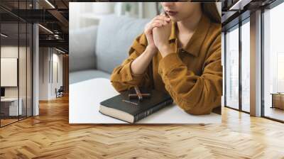 Believe faith charity, calm asian young woman show gratitude, folded hands in prayer feel grateful, meditating with her eyes closed, praying to request God for help. Religious, forgiveness concept. Wall mural