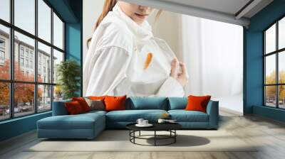 Dirty sauce stain cloth, asian young woman, girl wearing white shirt showing making on her cloth stain, spot dirty or smudge on clothes for cleaning before washing, maid female working at home concept Wall mural