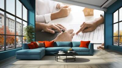 Hand of landlord, realtor pointing sign signature contract rental, purchase, buyer home or apartment with tenant, client after banker agreement mortgage, loan success or done. Property agent concept. Wall mural