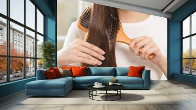 Health hair care, beauty makeup asian woman, girl holding hairbrush and brushing, combing her long straight hair looking at reflection in mirror in morning routine after salon treatment, hairstyle. Wall mural