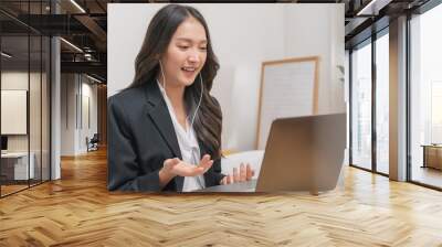 Online communication, attractive asian young woman in formal suit, using laptop computer having online virtual job interview meeting conversation on video call, distance remote recruitment conference. Wall mural