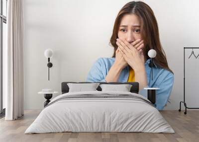 Portrait of pretty brunette hair, disgust smell bad breath strong asian young woman, girl covering, close her mouth with hand, expression face disgusting, dislike odor. Isolated on white background. Wall mural