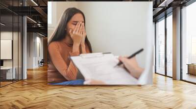 Psychology, depression. Sad, suffering asian young woman, girl consulting with psychologist, psychiatrist while patient counseling mental with doctor hand taking notes at clinic. Encouraging, therapy. Wall mural