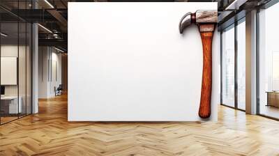 Hammer Time: A close-up shot of a weathered hammer with a wooden handle, lying horizontally on a clean white surface. The image evokes feelings of hard work, dedication, and construction. Wall mural