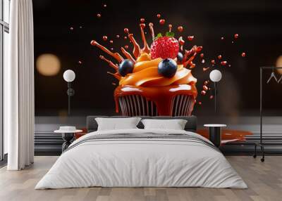 Sweet Explosion: A decadent cupcake, adorned with fresh berries and a vibrant orange frosting, is captured in a moment of delicious chaos as caramel sauce explodes around it. Wall mural