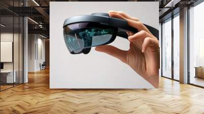 The Future of Vision: A hand holds up a sleek, futuristic augmented reality headset, showcasing a glimpse of a vibrant world within its lenses.   Wall mural