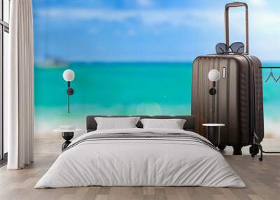 hand luggage suitcase on the beach Wall mural