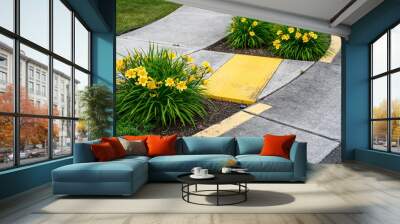 Bright yellow sidewalk guides on a corner crossing, with yellow daylilies planted on either side of the entrance
 Wall mural