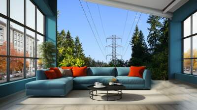 Power transmission lines and self-supporting tower through woods in warm evening light against a blue sky
 Wall mural