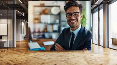 A man in a suit and tie smiles while working on a computer Wall mural