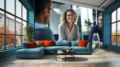 business, people and teamwork concept - smiling businesswoman with eyeglasses talking in office Wall mural