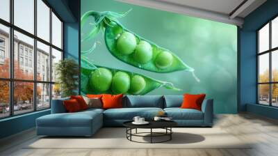 Close-up of fresh green pea pods on a bush with a blurred light green background Wall mural