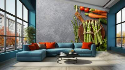 Fresh raw asparagus and other spring vegetables cooking in the kitchen, top view Wall mural